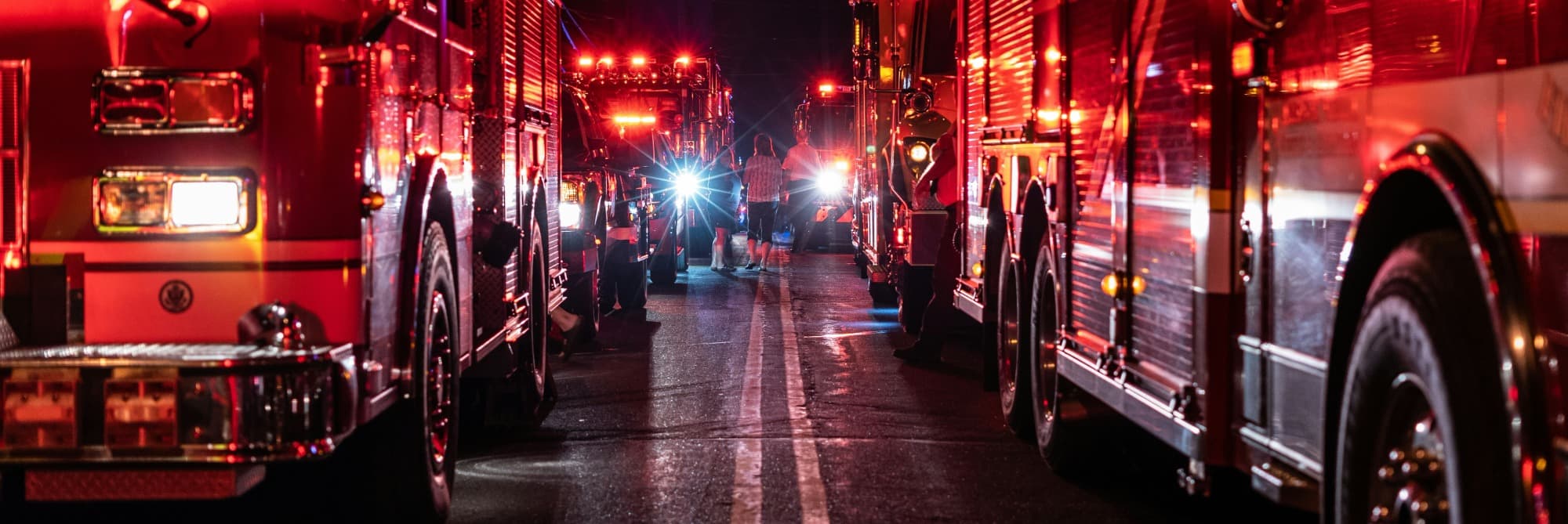 line of fire trucks at night long exposure
